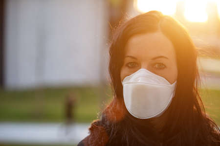 Woman in city with a face mask against infectionの写真素材