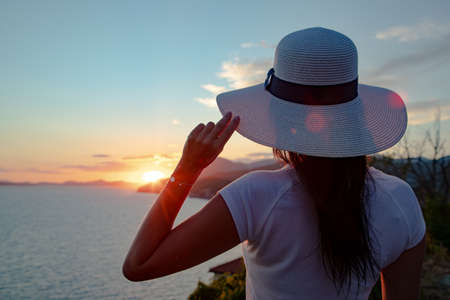 Gorgeous brunette woman in hat pose on the beachの写真素材