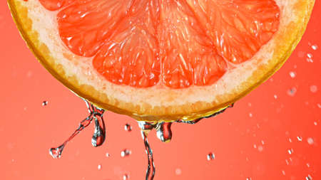 Fresh Grapefruit Slice with Water Splashの写真素材