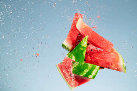 Freeze motion of fresh melon with splashing waterの写真素材