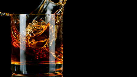 Ice Cube falling into Glass of Whisky