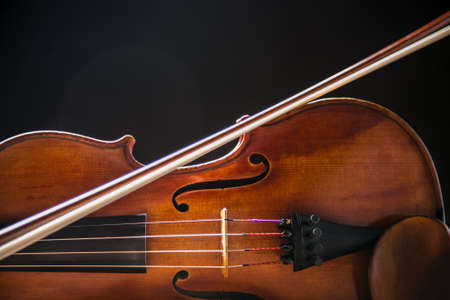 Close up of a violin isolated on a black backgroundの写真素材