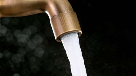 Drop of water drips from the tap.の写真素材