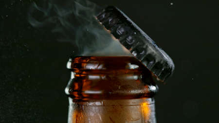 Freeze motion of opening beer bottle.