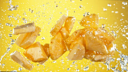 Fresh pineapple flying with water splashesの写真素材