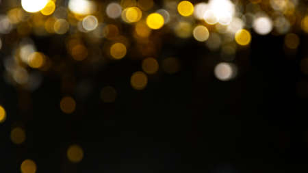Abstract gold particles on black background.の写真素材
