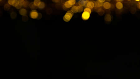 Abstract gold particles on black background.の写真素材