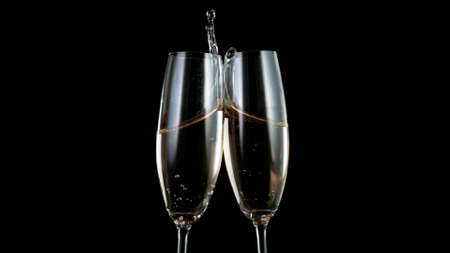 Freeze motion of toasting champagne flutes.