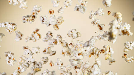 Freeze Motion of Popcorn Flying on Beige Backgroundの写真素材