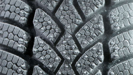 Freeze Motion of Car Tire with Icing and Falling Snow.の写真素材