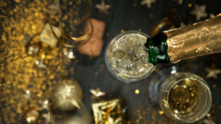 Champagne pouring in a glass from a bottle.の写真素材