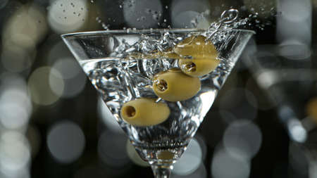 Falling olives into martini drinkの写真素材