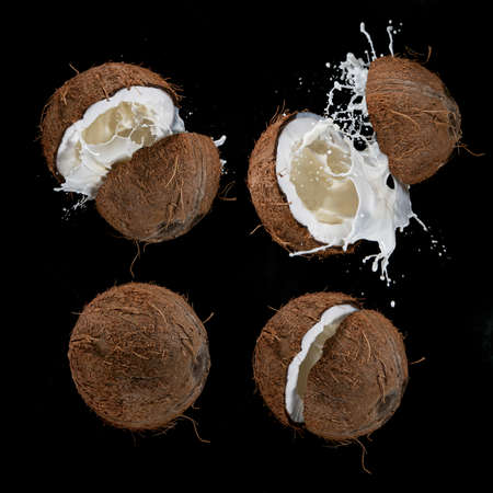 Cracked Coconuts milk water splash flying in the air.の写真素材