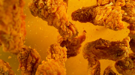 Freeze Motion Shot of Flying Fresh Fried Chicken Wings or Strips, Close-upの写真素材