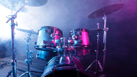 A drum set on a dark stage in the fog and neon lights.の写真素材