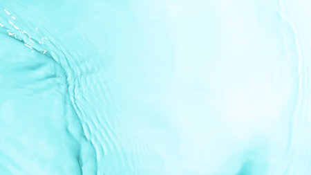 Close-up of splashing water surface on light blue background
