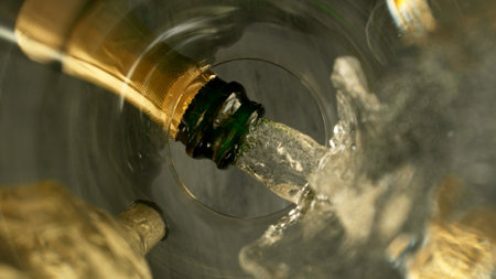 Freeze Motion Shot of Champagne Wine Pouring, Unique Angle of View from the Bottom of the Glassの写真素材