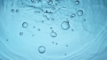 Freeze motion of splashing water drops on on light blue background