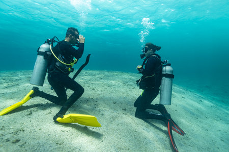 Diving instructor trains a novice who is learning to dive , underwater , Red sea .の写真素材