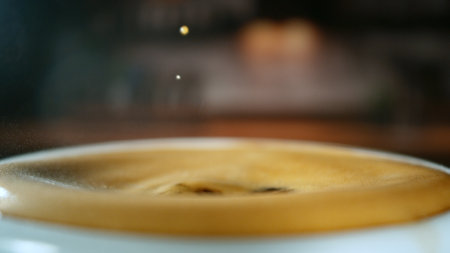Freeze Motion Detail Shot of Coffee Drop Falling into Fresh Espresso at 1000 fps . Filmed on High Speed Cinematic Camera at 1000 FPS .の写真素材
