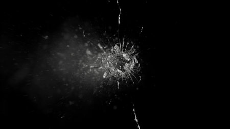 Close-up of gunshot through the glass, shattering against the black background