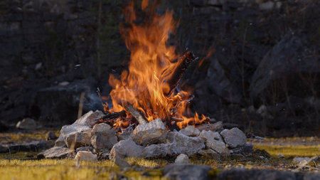 Beautiful Crackling Campfire in a Rocky Landscape , Sunrise , Authentic Placeの写真素材