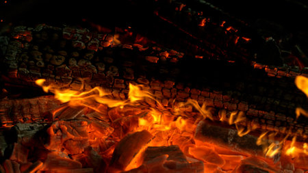 Close-up of Hot Embers with Flying Sparks . Concept of heating grills or ovensの写真素材