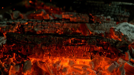 Close-up of Hot Embers with Flying Sparks . Concept of heating grills or ovensの写真素材