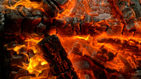 Close-up of Hot Embers with Flying Sparks . Concept of heating grills or ovensの写真素材