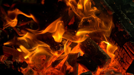 Close-up of Hot Embers with Flying Sparks . Concept of heating grills or ovensの写真素材