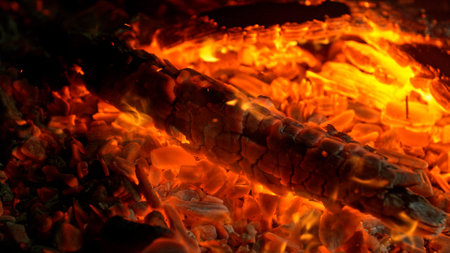 Close-up of Hot Embers with Flying Sparks . Concept of heating grills or ovensの写真素材