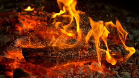 Close-up of Hot Embers with Flying Sparks . Concept of heating grills or ovensの写真素材