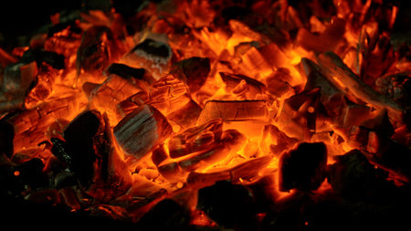 Close-up of Hot Embers with Flying Sparks . Concept of heating grills or ovensの写真素材