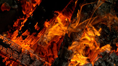 Close-up of Hot Embers with Flying Sparks . Concept of heating grills or ovensの写真素材