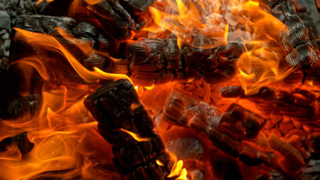 Close-up of Hot Embers with Flying Sparks . Concept of heating grills or ovensの写真素材