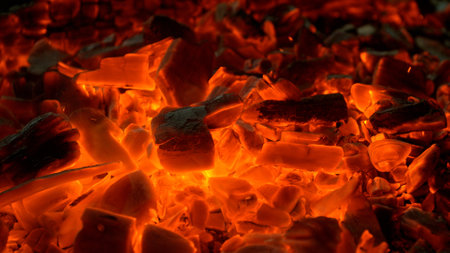 Close-up of Hot Embers with Flying Sparks . Concept of heating grills or ovensの写真素材