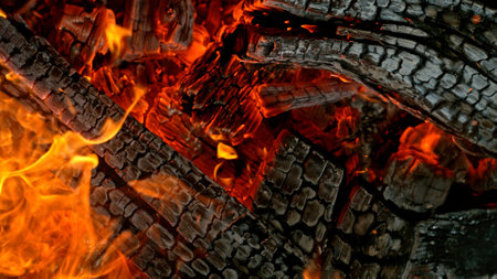 Close-up of Hot Embers with Flying Sparks . Concept of heating grills or ovens