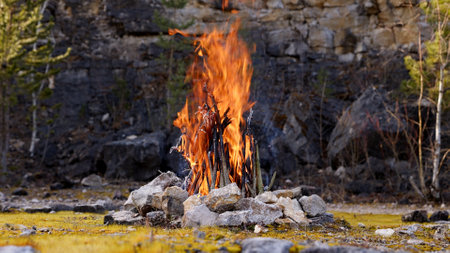 Beautiful Crackling Campfire in a Rocky Landscape , Sunrise , Authentic Placeの写真素材