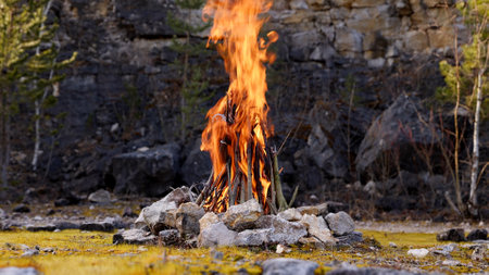 Beautiful Crackling Campfire in a Rocky Landscape , Sunrise , Authentic Placeの写真素材