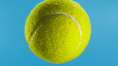 Detail Shot of a Yellow Tennis Ball on Blue Screen Background