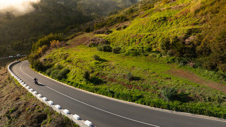 Motorcycle Rider Driving in High Mountain Landscape, Madeira Island , Portugalの写真素材