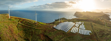 Solar energy panels photovoltaic cell and wind power plants on the seashore landscape for production of renewable green energyの写真素材