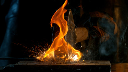 Close-up of blacksmith forging glowing hot iron on anvil with flying sparks