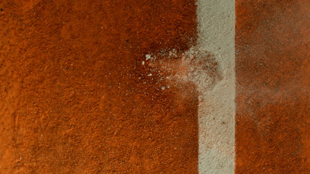 Freeze Motion Detail Shot of Tennis Ball Hitting a Clay Courtの写真素材
