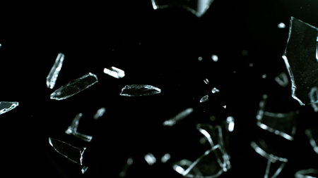 Freeze Motion Shot of Breaking Real Glass Isolated on Black Backgroundの写真素材