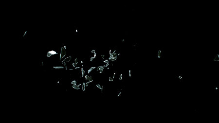 Freeze Motion Shot of Breaking Real Glass Isolated on Black Backgroundの写真素材