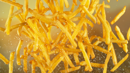 French Fries , Fried Potatoes Flying up in the Air . Concept of Junk Food