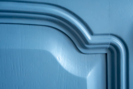Blue color door with two curved metal handles. A fragment of a blue kitchen door. Creative vintage background.の写真素材