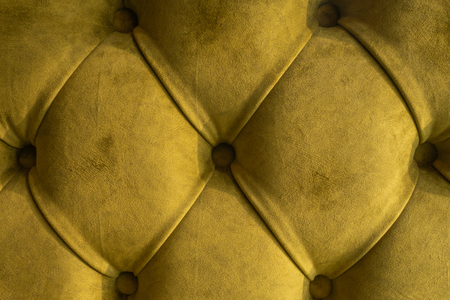 Green velvet capitone textile background, retro Chesterfield style checkered soft tufted fabric furniture diamond pattern decoration with buttons, close upの写真素材
