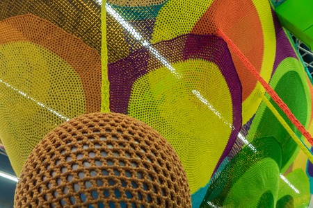 Rubber ball, covered with brown woven mesh. Abstract texture of multi-colored woven fabrics. Creative vintage backgroundの写真素材